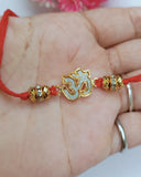 Golden Om Rakhi (Set Of 2)