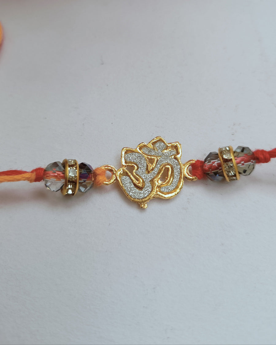 Golden Om Rakhi With Crystal (2 piece)