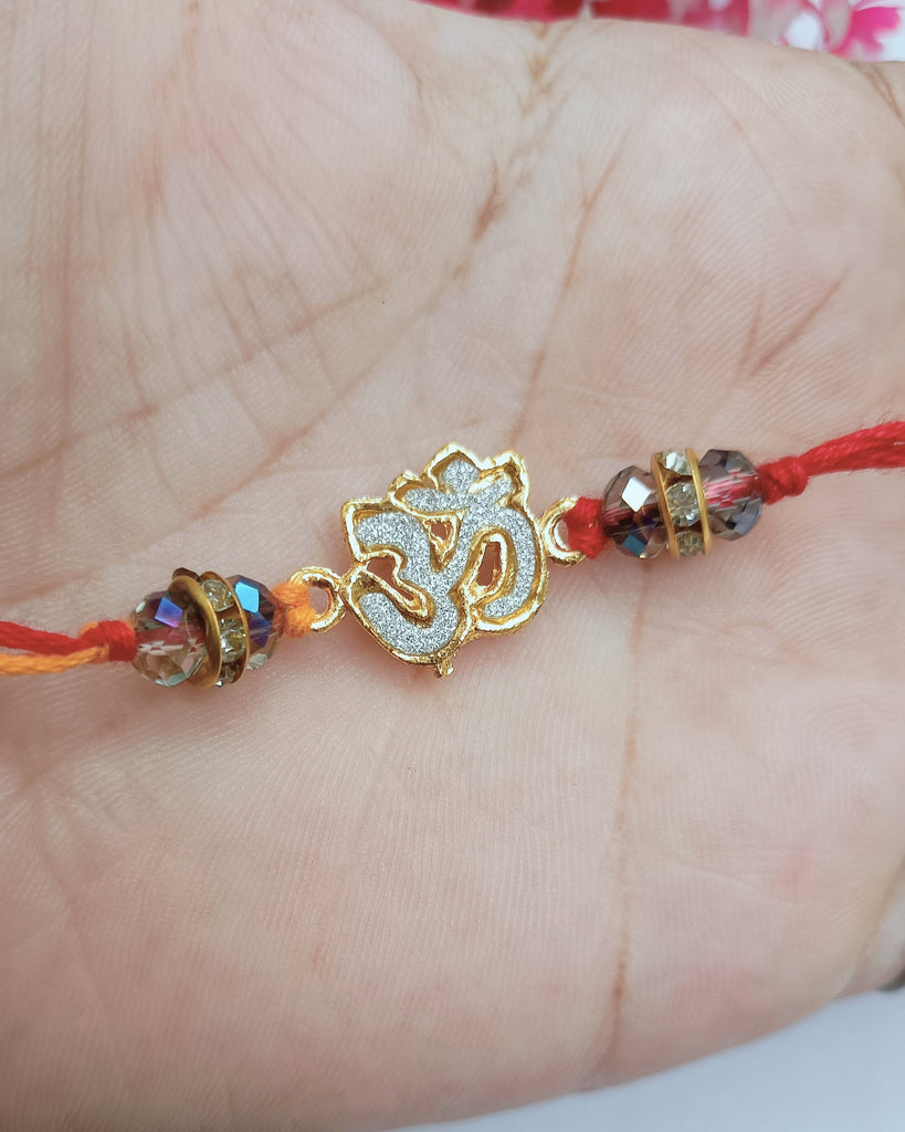 Golden Om Rakhi With Crystal (2 piece)