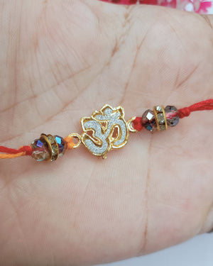 Golden Om Rakhi With Crystal (2 piece)